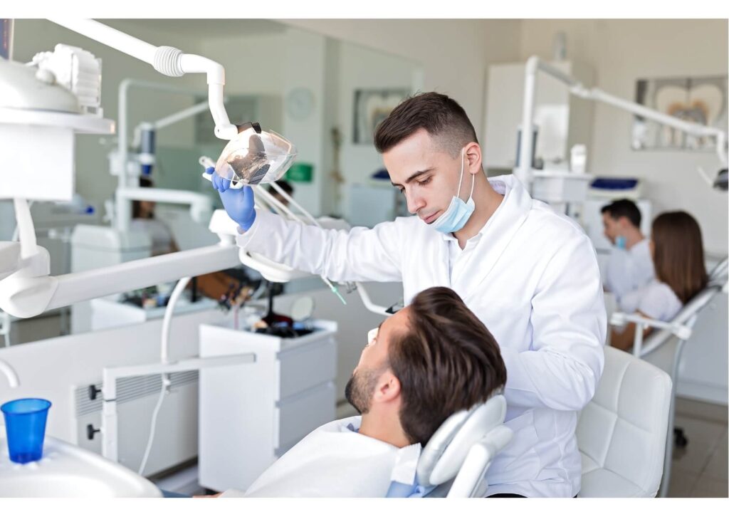 Dentist examining a patient during a consultation for nightguards for teeth grinding and bruxism treatment