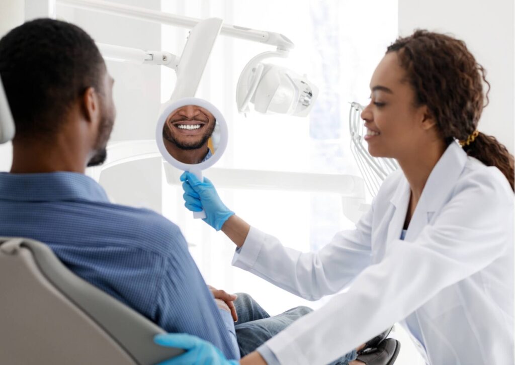 Dentist reviewing a patient's smile after discussing the effectiveness of teeth whitening strips and professional whitening options.