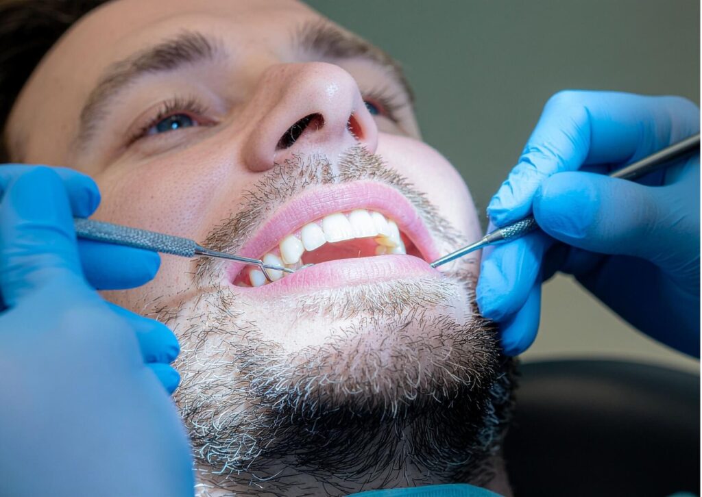 Dentist examining a patient's gums during a dental checkup to diagnose gingivitis and recommend appropriate gum disease treatment.
