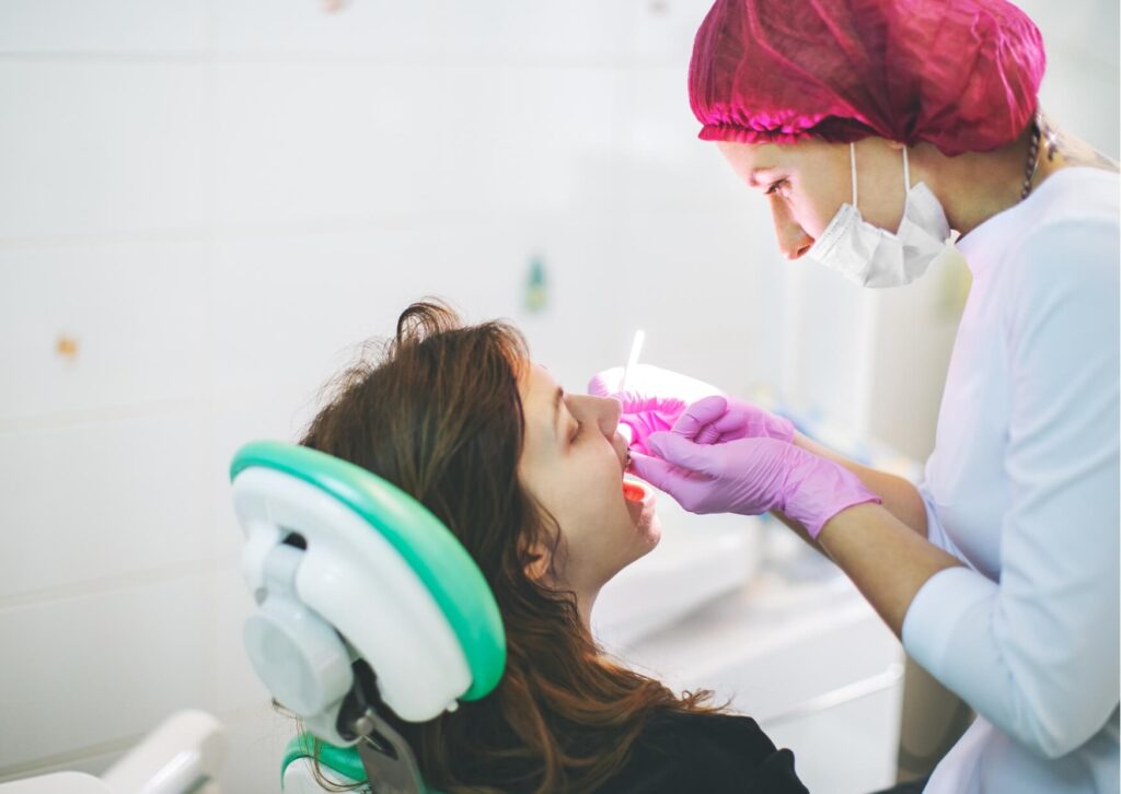 Patient receiving an orthodontic checkup to discuss whether eating candies with braces has damaged brackets or wires.