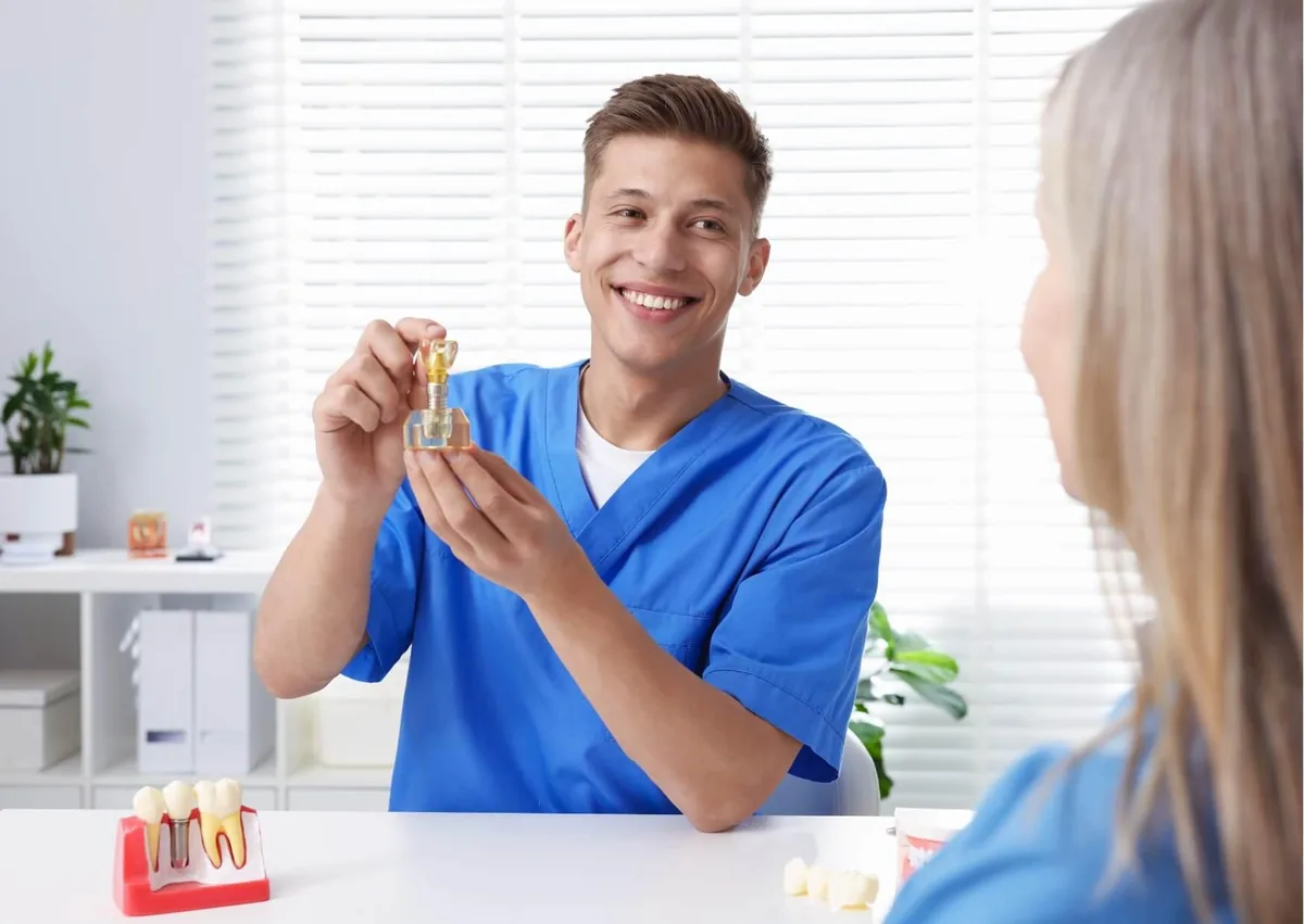 Dentist explaining the dental implant process and how long a tooth implant takes to a patient.