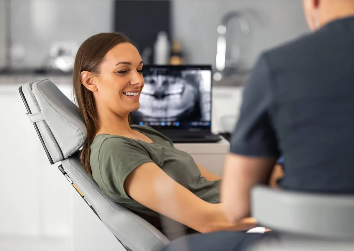 Patient discussing affordable dental implants with a dentist during a consultation and treatment planning visit.