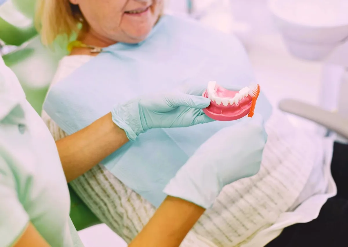 Dentist discussing implant care and long-term maintenance to support dental implant longevity.